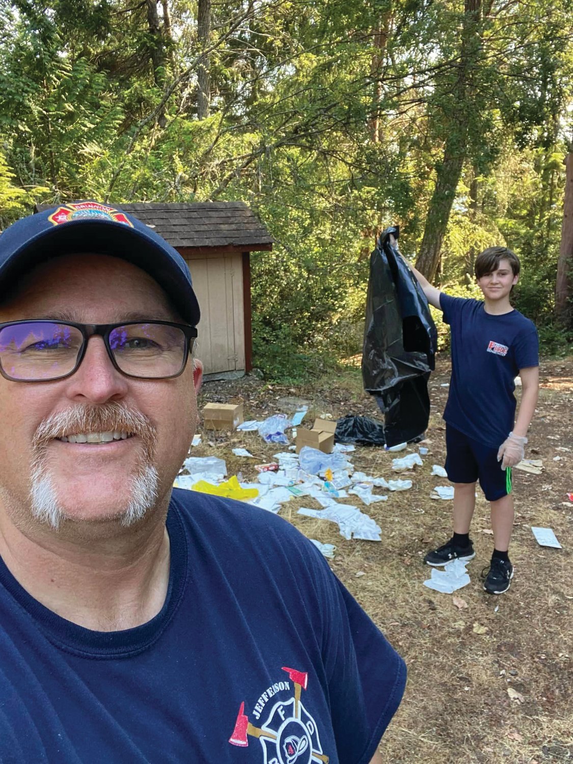 Brinnon Fire Commissioner Justin Matheson brought his son Tyler back to the scene all gloved up in order to help pick up the trash.